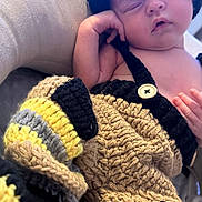 Rowan is registered to the contest to win money with this photo: baby, newborn, sleeping, crocheted_clothing, hat, colorful, cozy, cushion, infant, soft, handmade, cute, relaxing, child, portrait, resting, indoors, knitted, tiny, peaceful