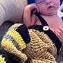 baby, newborn, sleeping, crocheted_clothing, hat, colorful, cozy, cushion, infant, soft, handmade, cute, relaxing, child, portrait, resting, indoors, knitted, tiny, peaceful
