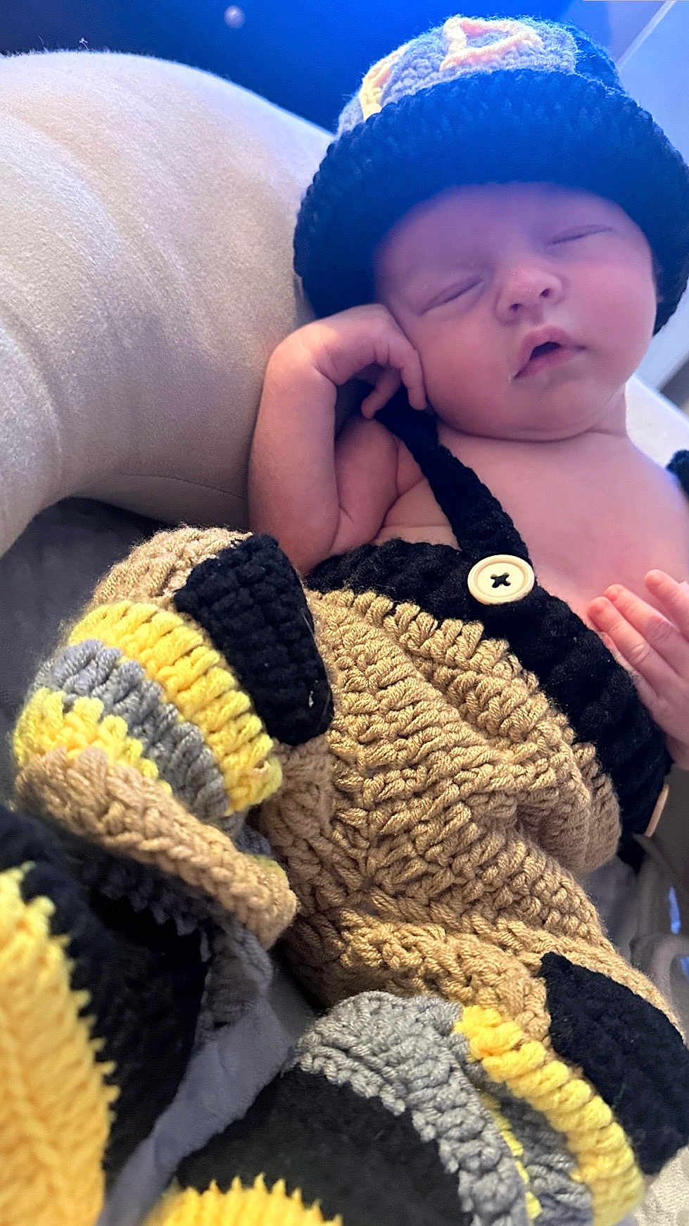 Rowan is registered to the contest to win money with this photo: baby, newborn, sleeping, crocheted_clothing, hat, colorful, cozy, cushion, infant, soft, handmade, cute, relaxing, child, portrait, resting, indoors, knitted, tiny, peaceful