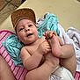 baby, cap, casual, clothing, cute, diaper, floor, foot, hand, happy, headwear, infant, lying_down, outdoor, person, playing, skin, smile, texture, towel