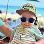 baby, beach, cap, child, colorful, cute, fashion, outdoor, person, portrait, sea, smile, striped_clothing, summer, summer_fun, sunglasses, sunny, toddler, umbrella, vacation