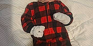 Oliver is registered to the contest to win money with this photo: baby, black, blanket, child, cozy, cute, festive, holiday, indoors, infant, lying_down, mittens, onesie, plaid, portrait, red, santa_hat, sleepy, smile, white