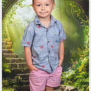 Mason is registered to the contest to win money with this photo: child, boy, portrait, standing, hands_in_pockets, smile, shirt, shorts, studio_background, fantasy_background, arch, stone_steps, greenery, plants, watermark, screenshot, phone_ui, email_app, indoor, casual_clothing