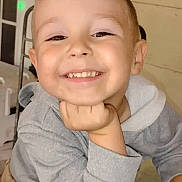 Mason joined the competition — help win amazing prizes! child, toddler, smile, face, teeth, hand_on_chin, hoodie, gray_sweatshirt, portrait, happy, cute, indoor, porch, wooden_wall, window, chair, glass_table, candid, young_child, eyes