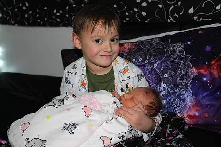 Lane is registered to the contest to win money with this photo: baby, baby_toddler_clothing, cheek, child, comfort, couch, event, flash_photography, fun, happy, holiday, iris, joy, pattern, person, room, sitting, skin, sleeve, smile