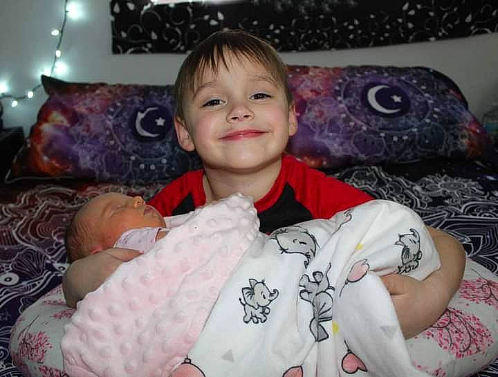 Lane is registered to the contest to win money with this photo: baby, baby_toddler_clothing, cheek, child, comfort, event, facial_expression, fun, happy, iris, joy, linens, pattern, person, room, sitting, sleeve, smile, t_shirt, textile