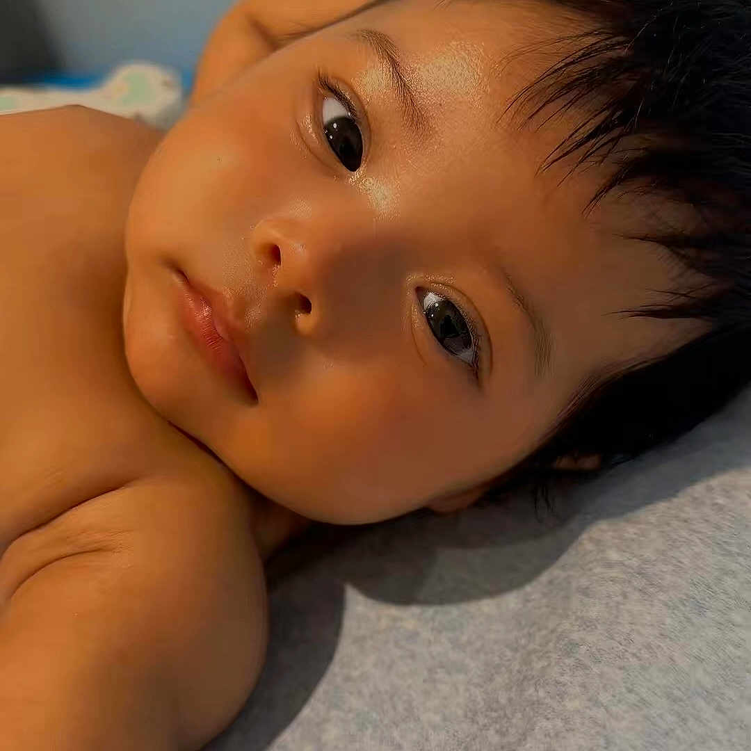 Shihaan joined the competition — help win amazing prizes! child, toddler, face, portrait, lying_down, bed, bedding, close_up, eyes, hair, skin, curious, calm, indoor, home, warm_lighting, soft_focus, head, shoulder, photography