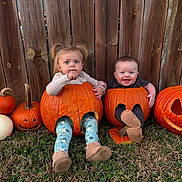 Wesley joined the competition — help win amazing prizes! autumn, baby, boots, carved_pumpkin, child, costume, cute, face, fall, grass, happy, legs, nature, outdoor, playful, pumpkin, sitting, smile, toddler, wooden_fence