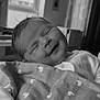 Oaklynn is registered to the contest to win money with this photo: newborn, baby, smiling, blanket, heart_pattern, indoor, cozy, sleeping, infant, portrait, soft_light, peaceful, cute, wrapped, child, happy, bedroom, window, monochrome, closeup