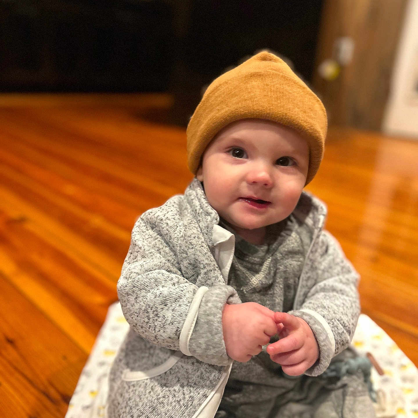 Cooper joined the competition — help win amazing prizes! baby, beanie, bodypart, cap, clothing, coat, face, finger, hand, hardwood, hat, head, indoors, interiordesign, jacket, pants, person, photography, portrait, wood