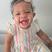 A'Zori joined the competition — help win amazing prizes! baby, child, smile, happy, curly_hair, headband, flower, dress, striped, pastel_colors, ruffle_sleeves, sitting, indoor, light_wall, cute, portrait, person, infant, young_child, joyful