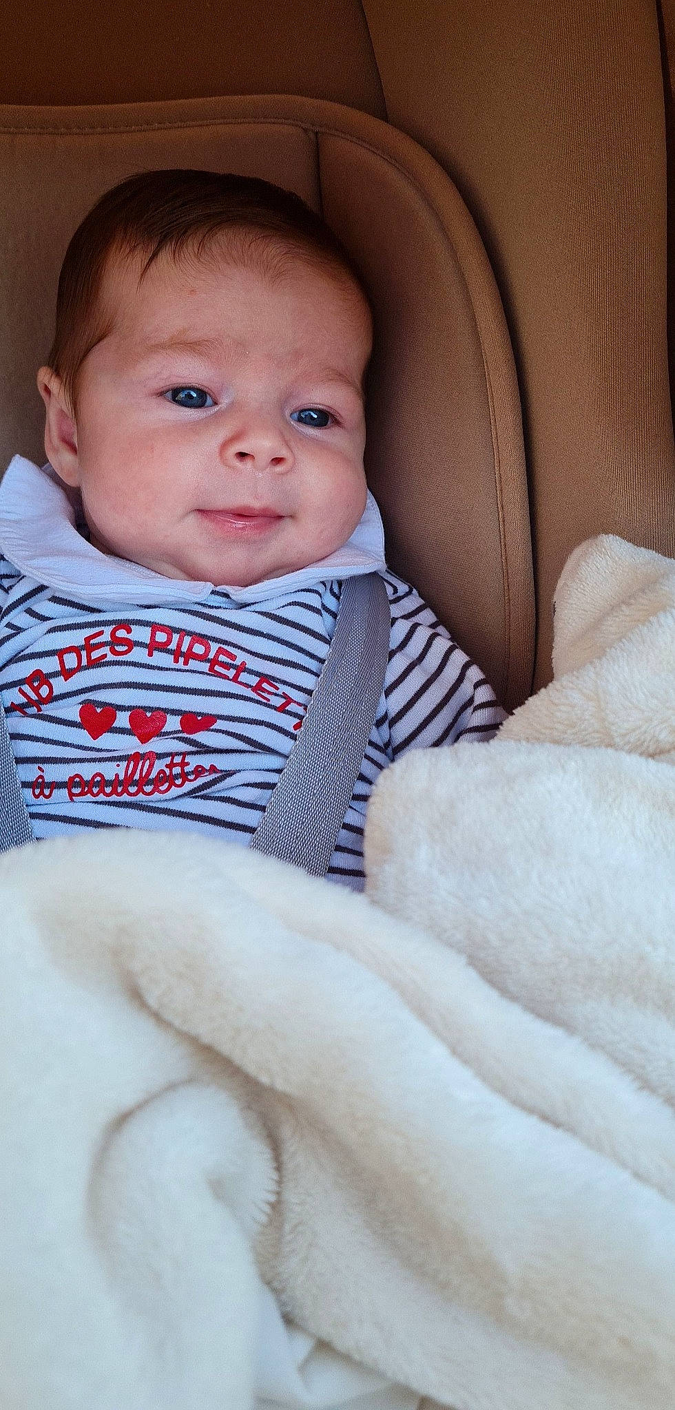 Thya participe au concours pour gagner de l'argent avec cette photo : azure, baby, baby_toddler_clothing, cheek, child, chin, comfort, eye, eyebrow, finger, human_body, iris, lip, neck, nose, outerwear, person, sitting, skin, sleeve