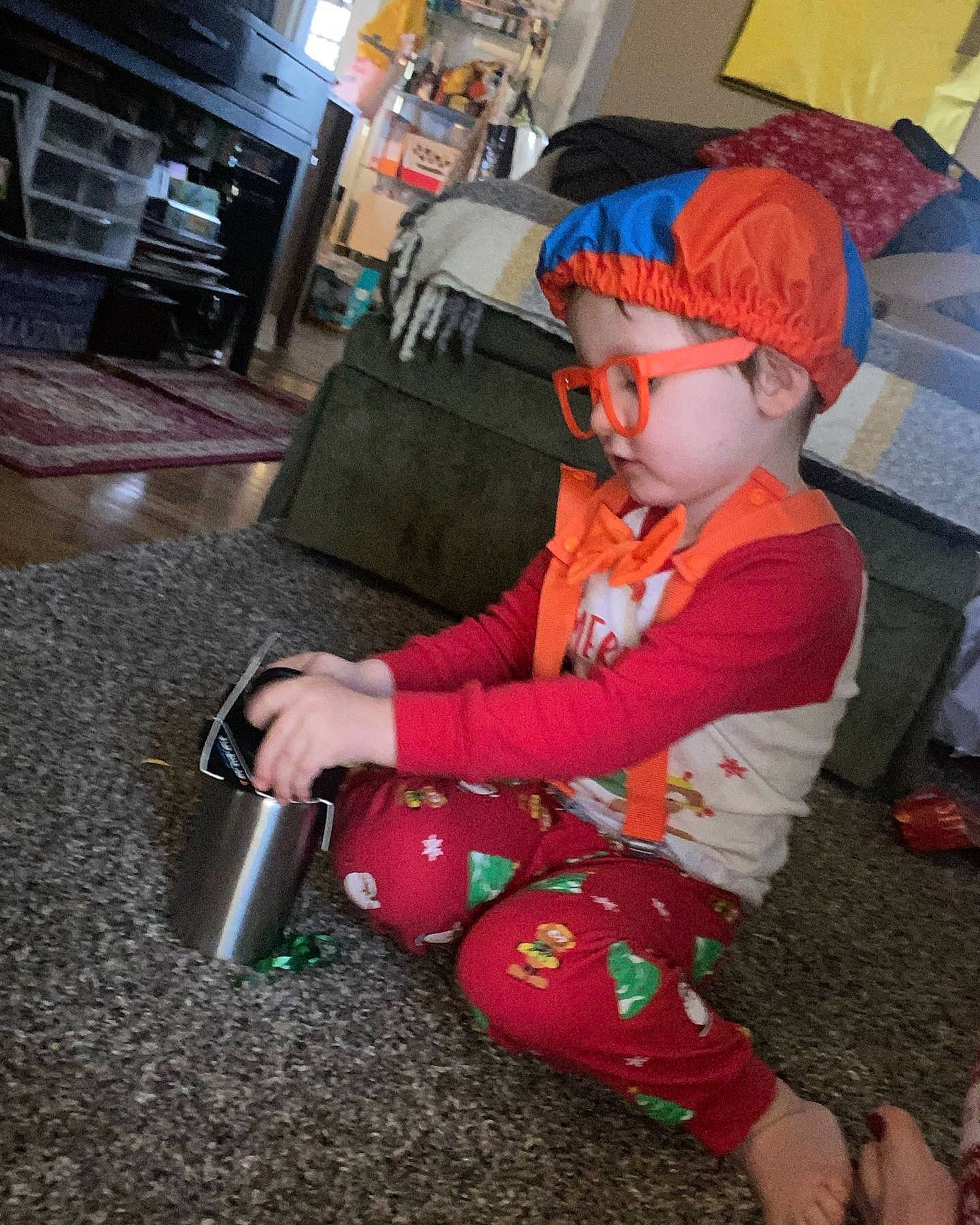 Uriah Dean joined the competition — help win amazing prizes! baby, baby_toddler_clothing, baseball_cap, cap, child, costume, eyewear, flooring, fun, goggles, hat, headwear, holiday, person, personal_protective_equipment, play, sandal, sitting, sunglasses, toddler