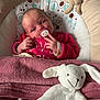 baby, baby_seat, blanket, child, comfort, cushion, cute, face, hand, head, indoor, infant, newborn, pacifier, pink_clothing, plush_toy, resting, sleepy, smiling, soft_toy