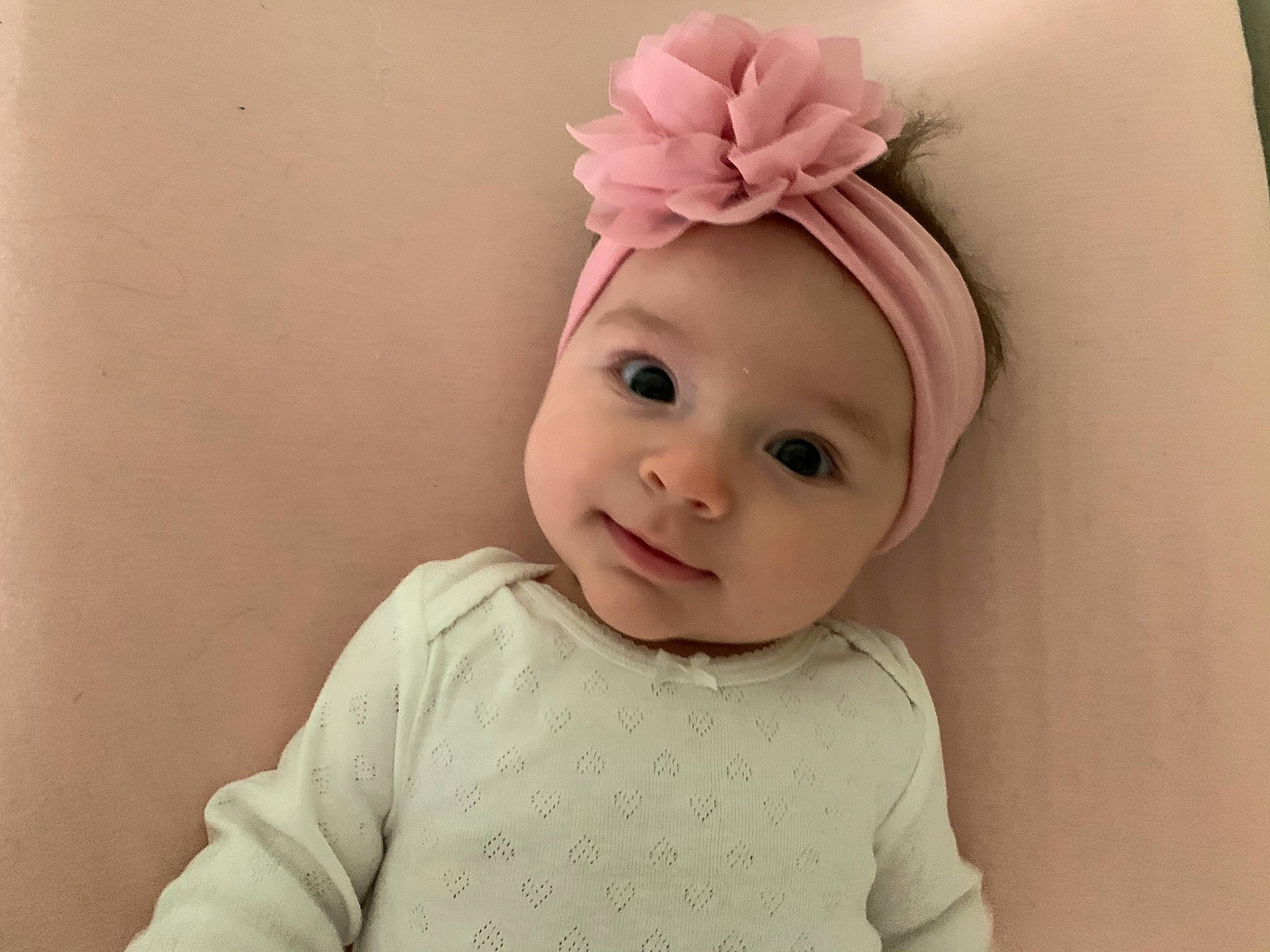 Althea is registered to the contest to win money with this photo: baby, baby_toddler_clothing, cap, cheek, child, costume_hat, ear, eyebrow, eyelash, happy, headband, headgear, headpiece, headwear, lip, person, petal, pink, sleeve, smile