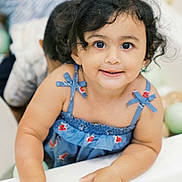 Arya joined the competition — help win amazing prizes! toddler, child, smiling, blue_dress, curly_hair, face, happy, portrait, indoor, hands, cute, young_child, person, people, baby, fashion, close_up, infant, skin, expression