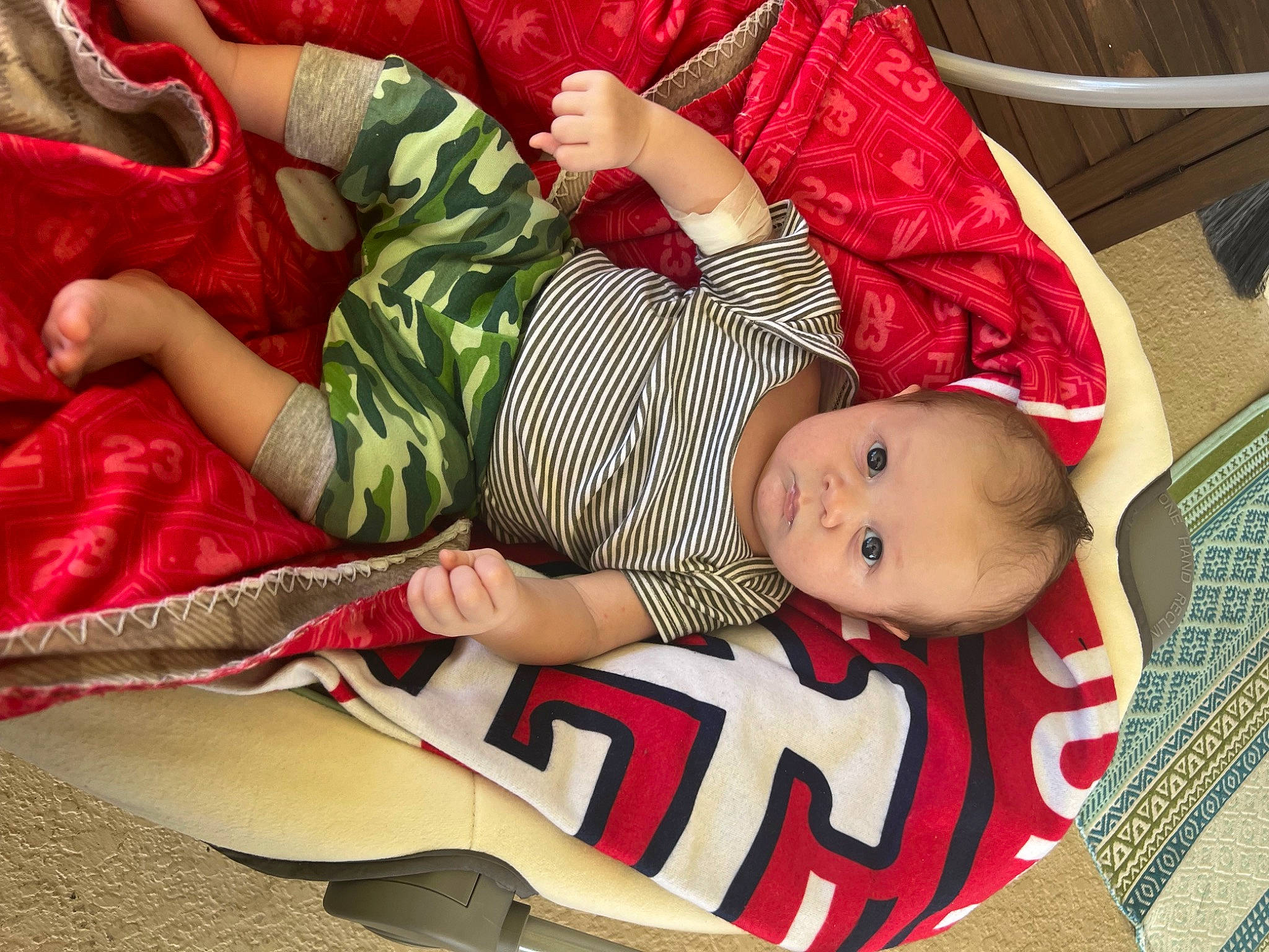 Brock joined the competition — help win amazing prizes! baby, baby_products, baby_toddler_clothing, child, comfort, finger, hand, lap, leg, linens, nail, pattern, person, red, sitting, skin, sleeve, smile, textile, thigh