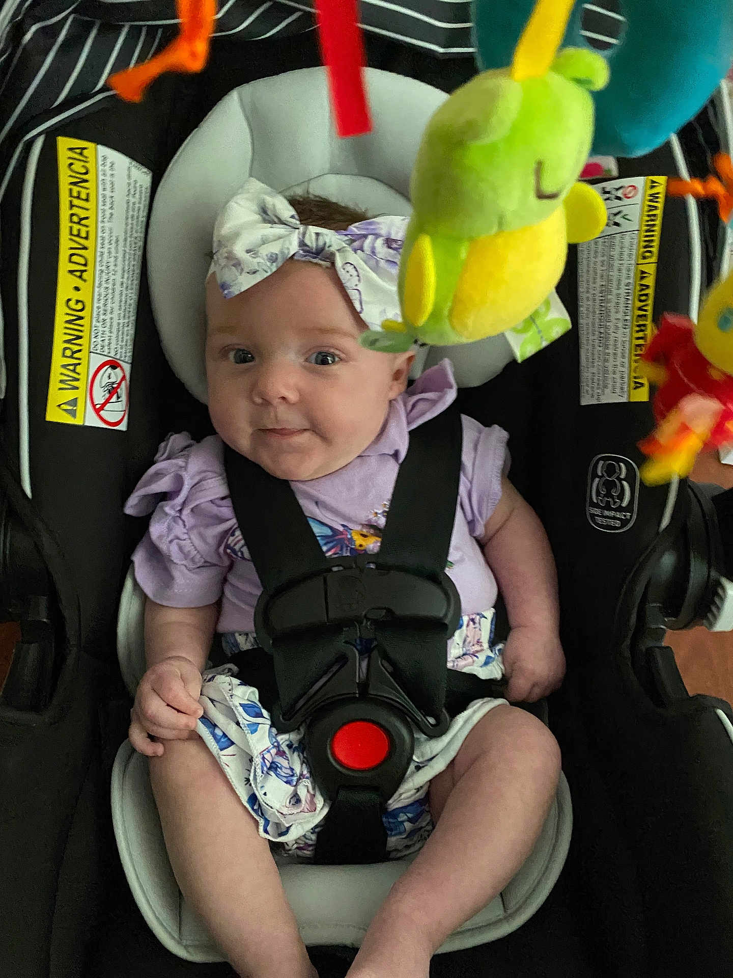 Aniyah joined the competition — help win amazing prizes! baby, car_seat, child, infant, toddler, bow, headband, toy, colorful, safety_harness, clothing, expression, indoor, cute, seat, child_safety, person, smile, face, closeup