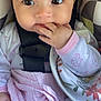 Elliana is registered to the contest to win money with this photo: baby, child, infant, face, hand, fingers, blanket, car_seat, clothing, cute, eyes, portrait, indoor, pink, white, patterned_blanket, safety_buckle, young, person, comfortable