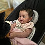 Elliana is registered to the contest to win money with this photo: baby, infant, smiling, blanket, stuffed_toy, plush, baby_seat, indoor, child, cute, happy, person, clothing, pink, comfort, playful, young, face, skin, home