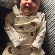 Micah joined the competition — help win amazing prizes! baby, child, infant, overalls, animal_patches, socks, cushion, chair, striped, soft_light, cute, smiling, cozy, indoors, portrait, person, clothing, fabric, texture, comfortable