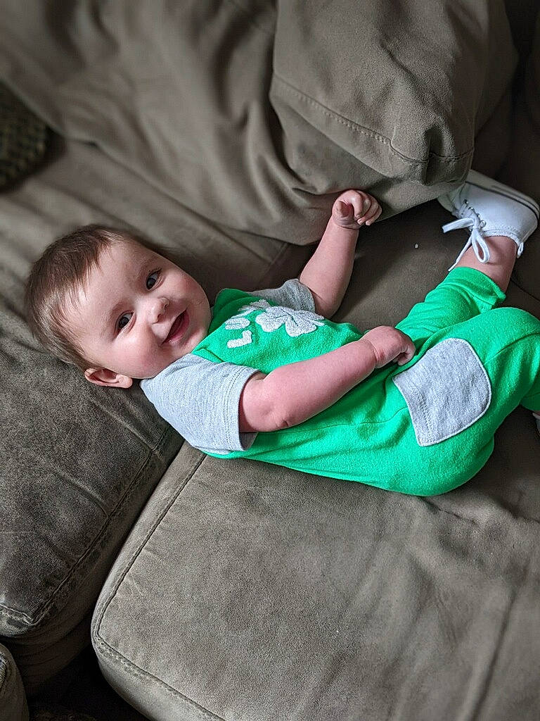James is registered to the contest to win money with this photo: baby, baby_toddler_clothing, child, comfort, elbow, flash_photography, grass, joy, knee, lap, linens, mammal, nap, person, room, sitting, sleeve, sock, t_shirt, toddler