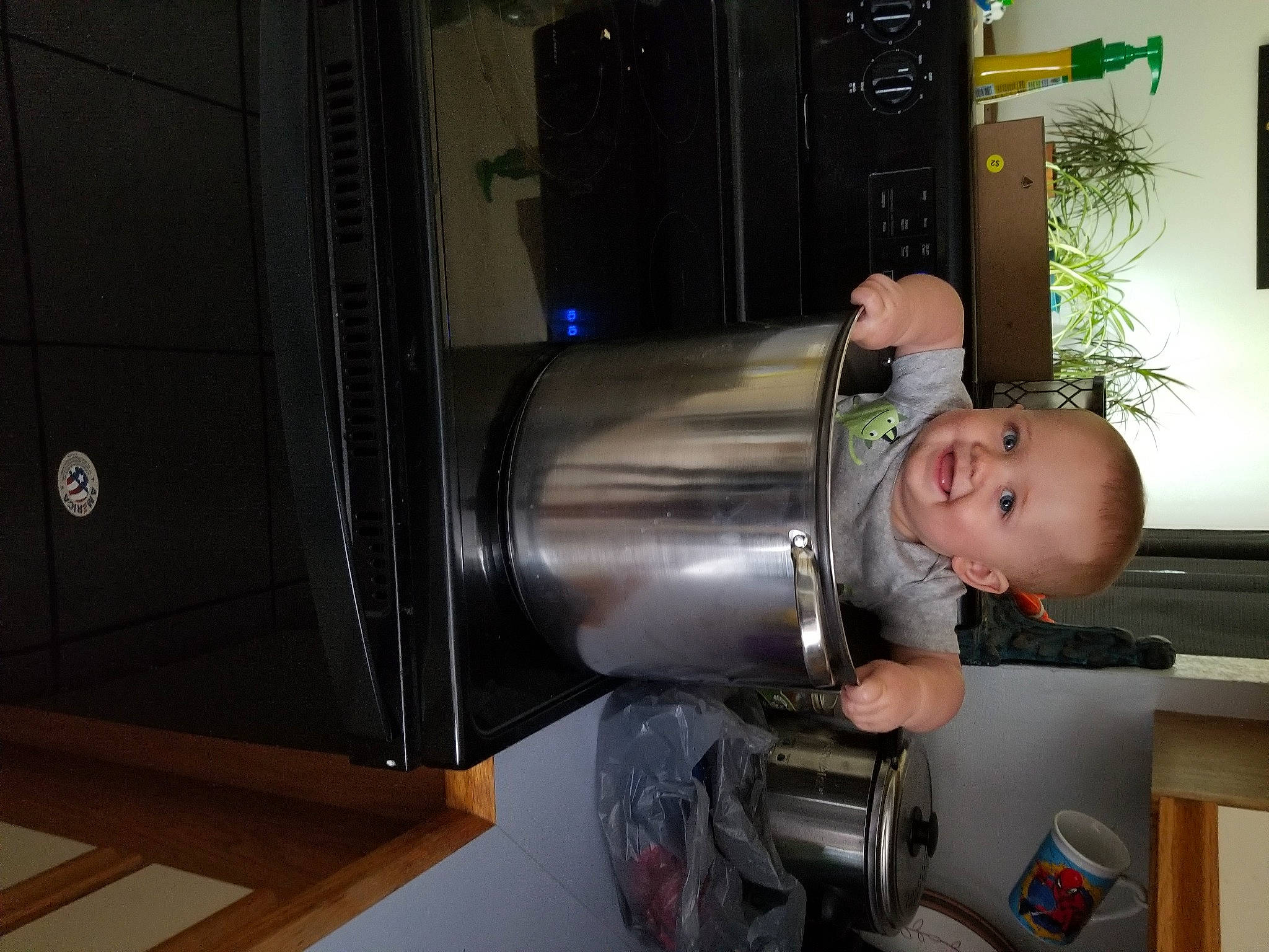 Timothy is registered to the contest to win money with this photo: baby, baby_toddler_clothing, engineering, flowerpot, fun, gas, houseplant, joy, machine, person, picture_frame, plant, room, smile, toddler, wood