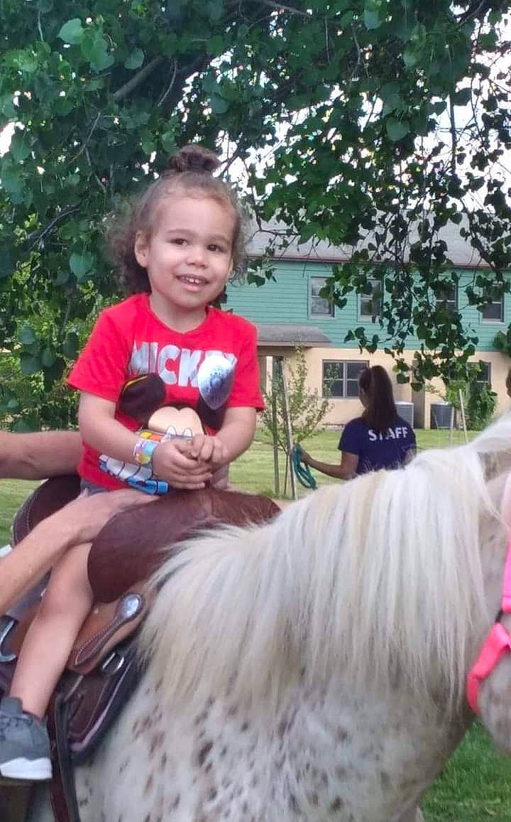 Shannon Jr is registered to the contest to win money with this photo: bridle, equestrianism, event, fun, grass, hairstyle, happy, horse, horse_supplies, horse_tack, joy, pack_animal, person, photograph, plant, recreation, shorts, smile, t_shirt, toddler