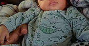 Davonta is registered to the contest to win money with this photo: baby, blanket, child, comfort, couch, cozy, cute, dinosaur_pajamas, face, furniture, hand, indoor, infant, pattern, person, rest, sleep, sleeping, toy, young