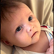 Enzo is registered to the contest to win money with this photo: baby, infant, close_up, face, eyes, skin, blanket, clothing, newborn, person, portrait, cute, soft_light, indoors, child, expression, head, care, sleepwear, young