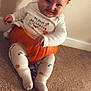 Enzo is registered to the contest to win money with this photo: baby, child, pumpkin, orange_hat, halloween, costume, carpet, white_shirt, leggings, socks, smile, indoor, cheeky, cute, holiday, seasonal, fun, playful, person, portrait