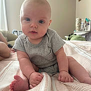 Kacey joined the competition — help win amazing prizes! baby, bedspread, blue_eyes, child, cozy, curious, cute, feet, furniture, gray_clothing, hands, indoors, infant, person, portrait, room, sitting, skin, soft_lighting, striped