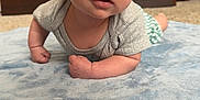 Kacey is registered to the contest to win money with this photo: arms, baby, blue_blanket, carpet, child, closeup, crawling, curious, eyes, face, floor, furniture, green_shorts, home, indoor, infant, person, short_sleeve_shirt, soft_texture, wooden_dresser