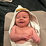 Kacey is registered to the contest to win money with this photo: baby, infant, smiling, towel, hooded_towel, duck_design, happy, bare_chest, skin, mat, blanket, textile, indoor, cute, child, person, portrait, relaxation, comfort, newborn