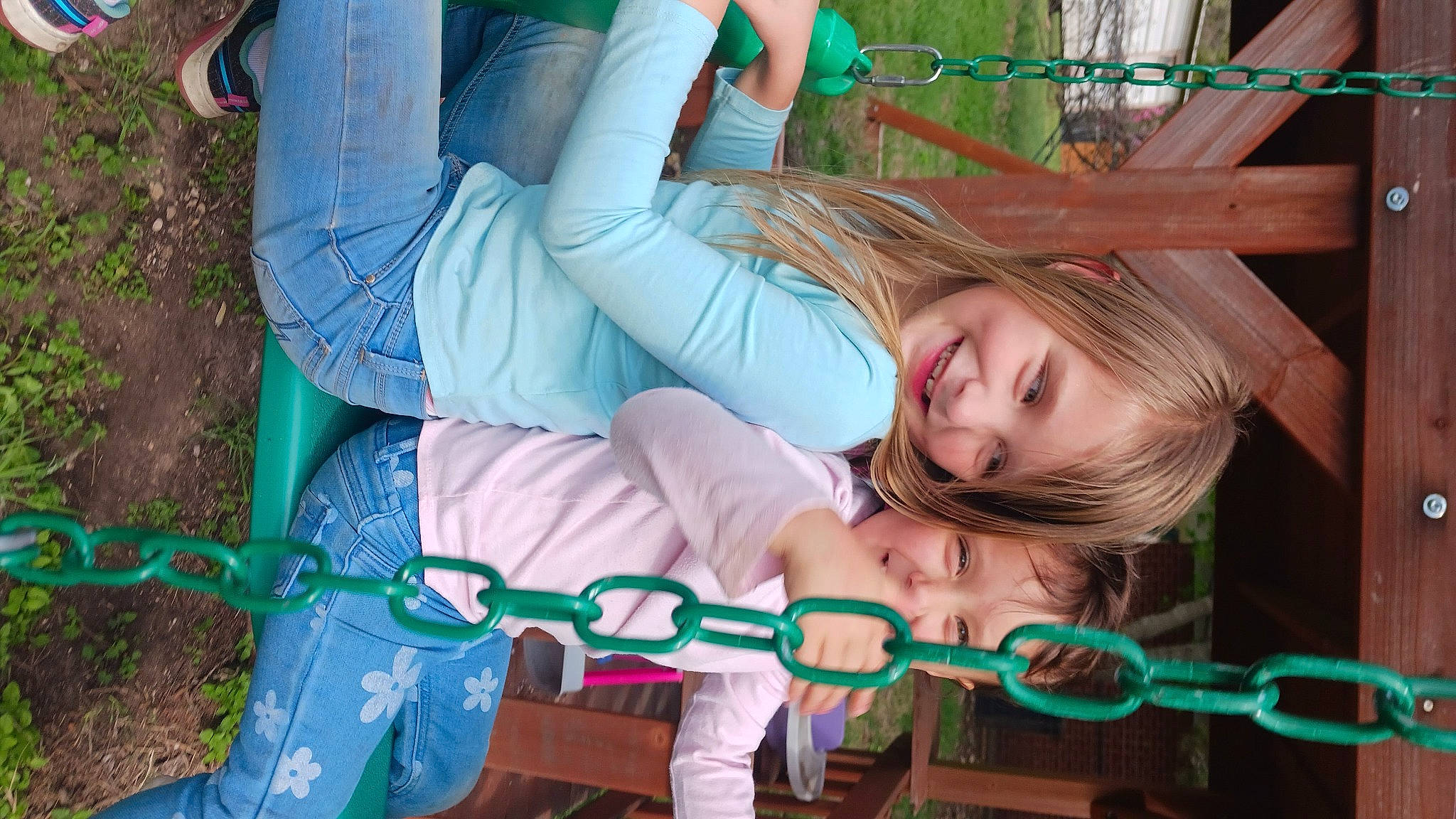 Emmalie is registered to the contest to win money with this photo: child, comfort, fun, grass, green, happy, jewellery, joy, leisure, outdoor_play_equipment, people_in_nature, person, plant, play, recreation, sitting, skin, smile, swing, toddler