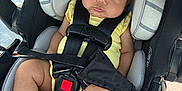 Peyton joined the competition — help win amazing prizes! baby, car_seat, child, yellow_clothing, headband, fan, straps, seatbelt, infant, cute, indoors, sitting, person, chubby_cheeks, foot, legs, black_straps, gray_cushion, car_interior, secure