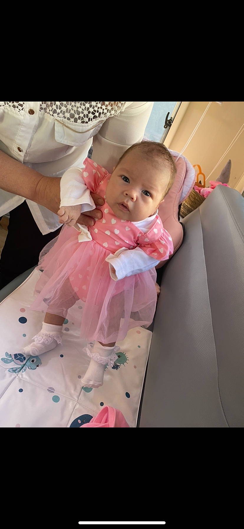 Inaya participe au concours pour gagner de l'argent avec cette photo : baby, baby_products, baby_safety, baby_toddler_clothing, chair, child, comfort, dress, event, facial_expression, fashion_accessory, fun, happy, magenta, peach, person, pink, sitting, sleeve, smile