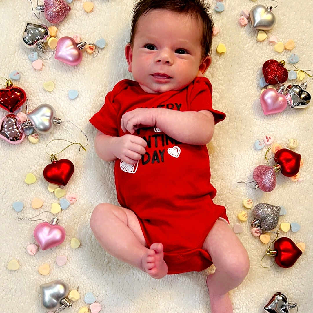 Asher is registered to the contest to win money with this photo: accessories, animal, baby, bead, bodypart, clothing, earring, face, finger, gemstone, hand, head, jewelry, necklace, newborn, person, photography, portrait, sitting, t_shirt