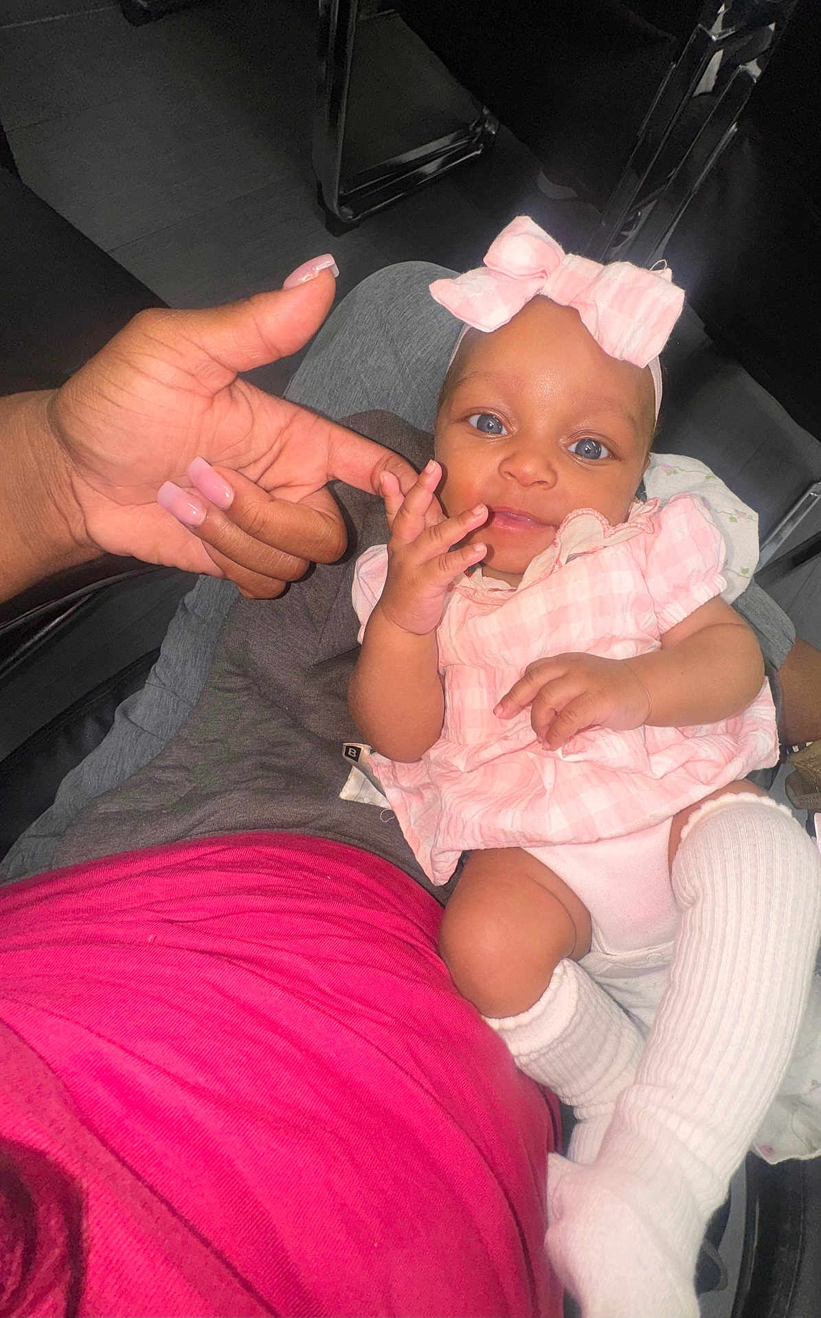 Harmony is registered to the contest to win money with this photo: baby, child, infant, pink_clothing, headband, bow, hand, finger, person, sitting, leg_warmers, white_socks, cute, indoor, human, skin, nail_polish, closeup, holding, playful