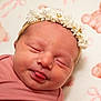 newborn, baby, sleeping, face, headband, flower, pink, blanket, teddy_bear, pattern, tongue, closeup, infant, cute, soft, portrait, child, indoors, peaceful, resting