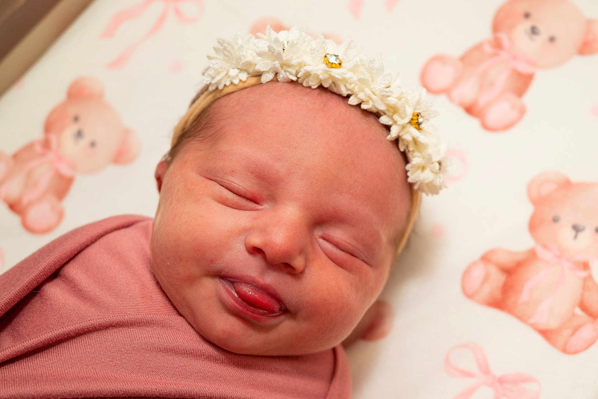 Verafaye is registered to the contest to win money with this photo: newborn, baby, sleeping, face, headband, flower, pink, blanket, teddy_bear, pattern, tongue, closeup, infant, cute, soft, portrait, child, indoors, peaceful, resting