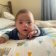 Gabriel joined the competition — help win amazing prizes! baby, infant, pillow, bedroom, bed, blanket, animal_print, hand, face, eyes, curious, clothing, child, indoors, soft_lighting, head, expression, young, person, comfort