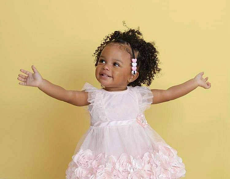 Jainiah is registered to the contest to win money with this photo: baby_toddler_clothing, day_dress, dress, eye, face, facial_expression, flash_photography, gesture, hairstyle, happy, headgear, iris, joy, neck, one_piece_garment, person, pink, purple, skin, sleeve