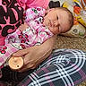 Lydia joined the competition — help win amazing prizes! baby, infant, person, pajamas, pink_clothing, plaid_leggings, pacifier, hand, carpet, snack_bags, floor, cherry_pattern, holding, cute, resting, indoor, casual, cozy, family, toddler