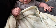 Noah-James joined the competition — help win amazing prizes! baby, blanket, cushion, infant, indoor, person, face, hand, cozy, furniture, woven_basket, soft_texture, expression, clothing, plush, portrait, comfort, child, cute, home