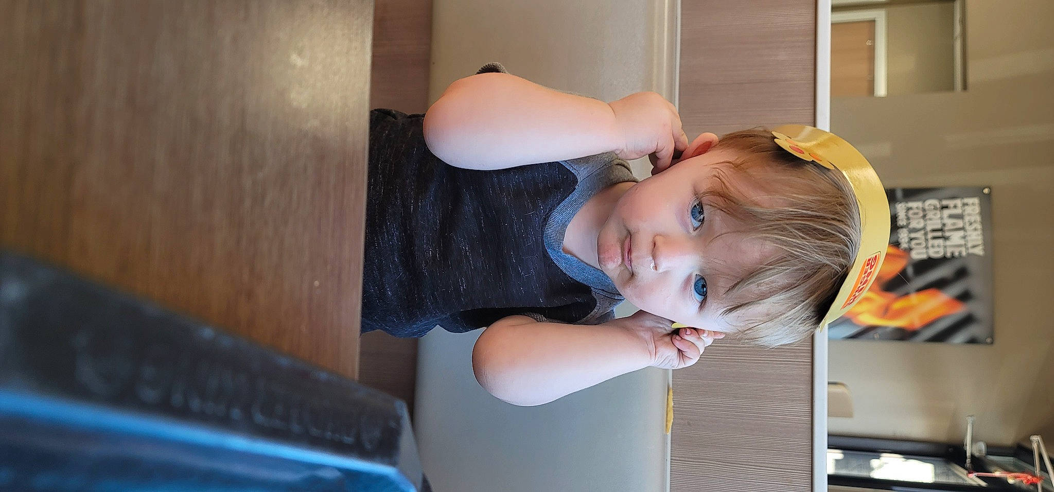 Niklaus joined the competition — help win amazing prizes! baby_toddler_clothing, child, chin, comfort, elbow, electric_blue, fun, happy, hat, person, room, shoulder, sitting, smile, t_shirt, toddler, vacation, window, wood