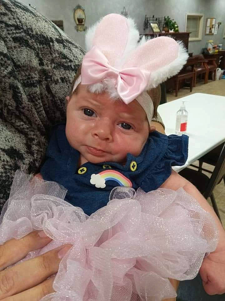 Ernestine is registered to the contest to win money with this photo: baby, baby_toddler_clothing, chair, child, costume, costume_hat, dress, event, fashion_accessory, fashion_design, formal_wear, fun, hair_accessory, happy, hat, headpiece, headwear, party_supply, person, pink
