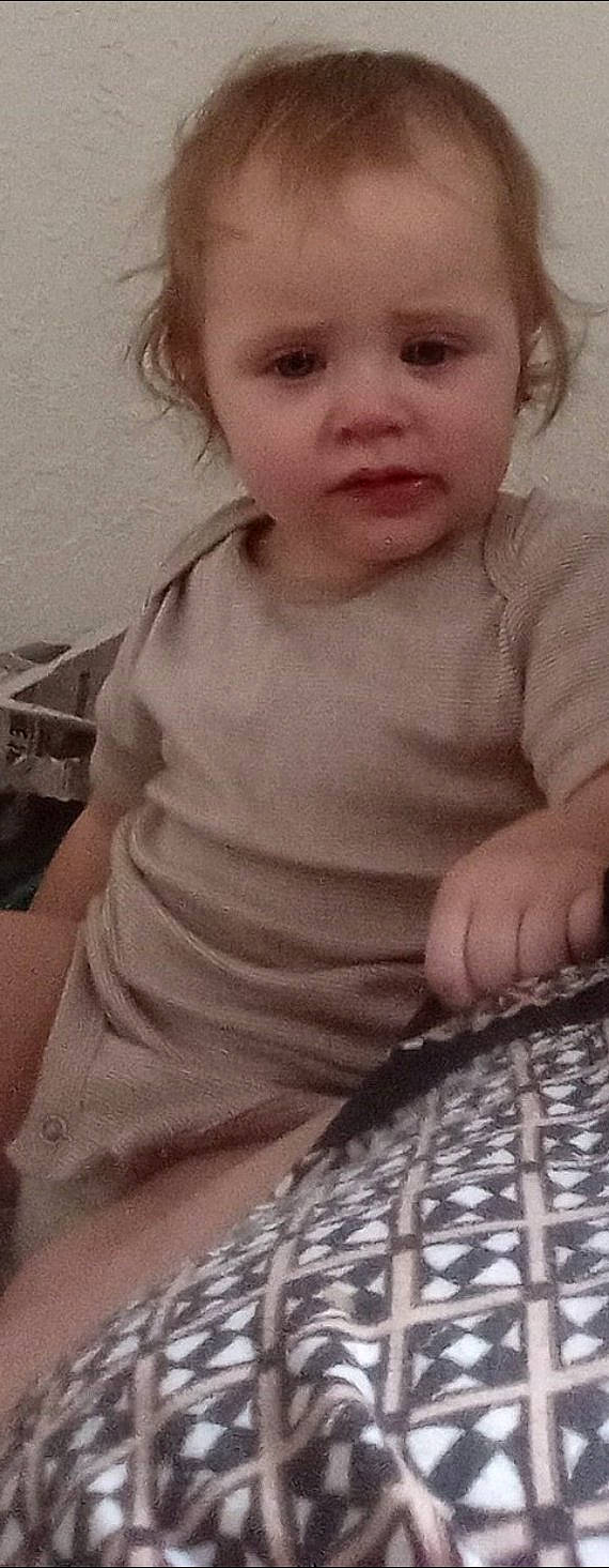 Ernestine is registered to the contest to win money with this photo: baby, baby_toddler_clothing, cheek, child, eyelash, face, flooring, fun, hand, head, iris, lip, mouth, nose, person, skin, sleeve, smile, t_shirt, toddler