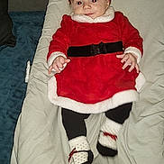 Lalia a rejoint le concours — aidez-le/la à gagner de superbes lots ! baby, infant, red_dress, headband, bow, socks, blanket, cushion, indoor, carpet, smiling, person, child, cute, holiday, christmas_outfit, lying_down, clothing, face, footwear