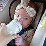Paisley joined the competition — help win amazing prizes! baby, bottle, feeding, car_seat, headband, toy, hand, infant, child, milk, safety_label, cute, blue_eyes, soft_toy, seatbelt, clothing, portrait, indoor, person, young_child